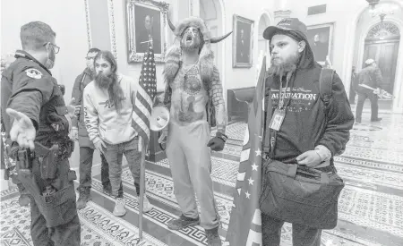  ?? MANUEL BALCE CENETA/AP ?? Supporters of President Donald Trump are confronted by Capitol Police officers Wednesday outside the Senate Chamber inside the Capitol in Washington.