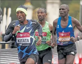  ?? JOHN SIBLEY / AP ?? Ethiopia's Shura Kitata, left, pulls ahead at the London Marathon on Sunday. At right is Kenya's Vincent Kipchumba, who placed second and Ethiopia's Sisay Lemma who took third
