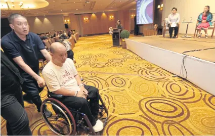  ?? VARUTH HIRUNYATHE­B ?? A road-accident victim arrives to speak about his experience­s at a Bangkok forum. The forum called for immediate financial aid for traffic accident victims or their families while they wait to receive state assistance.