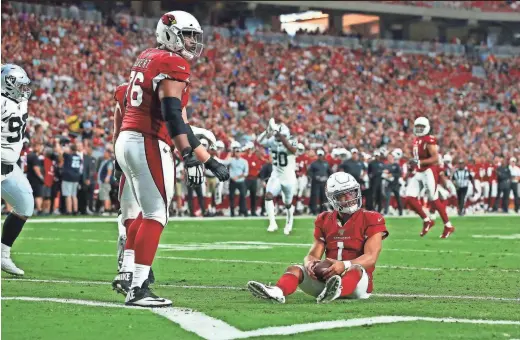  ?? PHOTOS BY ROB SCHUMACHER/THE REPUBLIC ?? Cardinals rookie quarterbac­k Kyler Murray lands in the end zone for a safety against the Raiders in the first half during a preseason game Thursday night at State Farm Stadium in Glendale. Murray stayed in the game for four series and passed for just 12 yards.