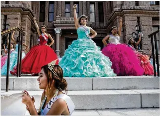  ?? TAMIR KALIFA/ AMERICAN-STATESMAN ?? Young Latinas in quinceañer­a dresses raise their fists Wednesday on the south steps of the Capitol after a dance protest of Senate Bill 4, the so-called sanctuary cities law that goes into effect in September. The protest was organized by Jolt, a...