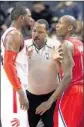  ?? Frank Gunn Associated Press ?? JAMAL CRAWFORD, right, of the Clippers and Patrick Patterson of the Raptors are separated by referee Bennie Adams.