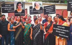  ?? AFP ?? People hold placards as they protest against the killing of Shraddha Walker by her live-in partner, in Mumbai, yesterday.