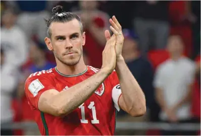  ?? ?? Wales’ forward Gareth Bale greets supporters at the end of the Qatar 2022 World Cup Group B football match against USA at the Ahmad Bin Ali Stadium in Al Rayyan, west of Doha on Monday.
