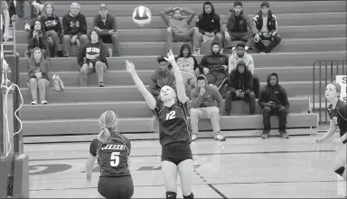  ?? Photo courtesy of JBU Sports Informatio­n ?? Central Christian John Brown senior setter Alyssa Arnold, middle, sets the ball for sophomore middle hitter Jessica Meyer during Saturday’s match at Central Christian (Kan.).