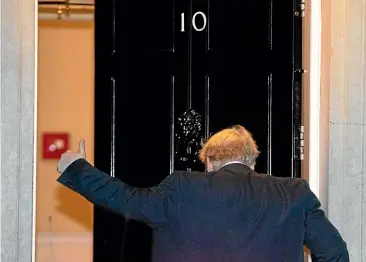  ?? AP ?? British Prime Minister Boris Johnson gives a thumbs-up as he arrives back at 10 Downing Street from the Houses of Parliament in London. Britons will be heading out to vote in the dark days of December after the House of Commons backed an early national vote that could break the country’s political impasse over Brexit.