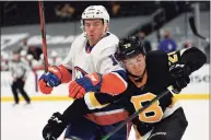  ?? Winslow Townson / Associated Press ?? The Bruins’ Curtis Lazar battles for position with the Islanders’ Anthony Beauvillie­r during the second period on Friday in Boston.