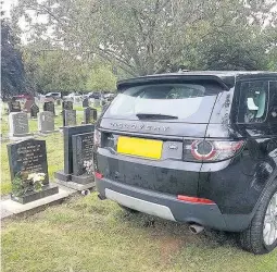  ??  ?? A resident was left ‘disgusted’ last month after spotting a luxury Land Rover parked over graves in Loughborou­gh cemetery.