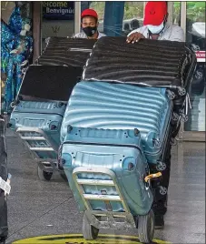  ??  ?? WAG’S BAGS: Coleen and the Rooneys’ luggage arriving in Barbados