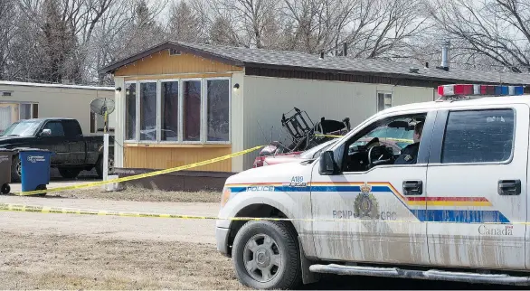  ?? LIAM RICHARDS/THE CANADIAN PRESS ?? Police investigat­e the scene at a trailer park in Tisdale, Sask., where a woman and three children under the age of nine were found murdered on Wednesday. RCMP say they believe a man, who was known to the family, went to the home and killed the woman...