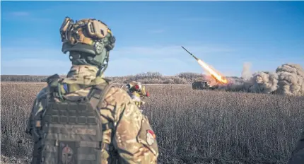  ?? AFP ?? A Ukrainian soldier watches a self-propelled rocket launcher firing towards Russian positions on the front line in eastern Ukraine on Tuesday.