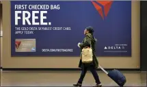  ?? THE ASSOCIATED PRESS ?? Some airline credit cards offer free checked bags, priority boarding and discounts on in-flight purchases.