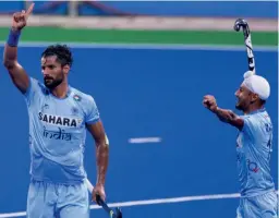  ??  ?? Rupinder Pal Singh (left) celebrates after scoring India’s first goal in their third place play-off match against New Zealand in Ipoh on Saturday. India won 4-0. —