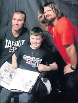  ??  ?? Liam Chase from Hinckley meets Randy Orton and AJ Styles at Birmingham Genting Arena