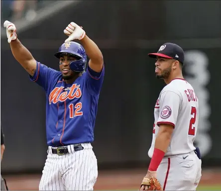  ?? COREY SIPKIN - THE ASSOCIATED PRESS ?? Washington Nationals shortstop Luis Garcia (2) looks on as New York Mets’ Francisco Lindor (12) gestures after his double scored Patrick Mazeika and Jonathan Villa during the eighth inning of a baseball game Sunday, Aug. 29, 2021, in New York.
