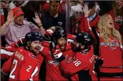  ?? ASSOCIATED PRESS ?? WASHINGTON CAPITALS forward Devante Smith-Pelly (center) celebrates his goal against the Vegas Golden Knights with Matt Niskanen (left) and Chandler Stephenson during the third period in Game 3 of the Stanley Cup Final Saturday in Washington.