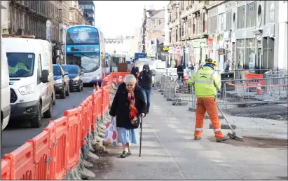 ??  ?? Pedestrian­s and drivers struggle along Sauchiehal­l Street in Glasgow as a major set of roadworks gets under way