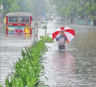  ?? REUTERS FILE ?? A man wades through a waterlogge­d road in Mumbai. In August, the city received about 30% of its annual rain in less than 24 hours.