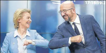  ?? AFP ?? DEAL DONE! European Commission president Ursula Von Der Leyen (left) and European Council chief Charles Michel bump elbows after a press conference following the marathon EU summit in Brussels.