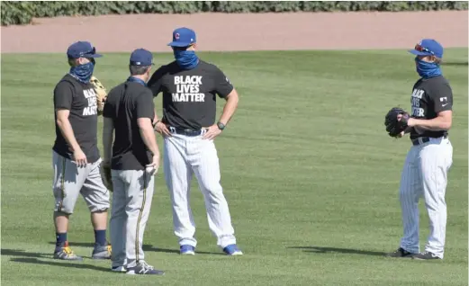  ?? DAVID BANKS/AP ?? Members of the Cubs and Brewers wear ‘‘Black Lives Matter’’ T-shirts while chatting before the season opener Friday at Wrigley Field.