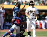  ?? NHAT V. MEYER/TRIBUNE NEWS SERVICE ?? Oakland Athletics' Nick Martini (38), who reacted to being hit with a pitch against the Texas Rangers in the third inning on Sept. 9 at the Coliseum in Oakland, had one of many big hits in Wednesday's 10-0 win over Baltimore.