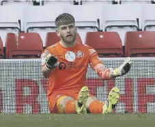  ??  ?? Lee Burge looks dejected after conceding a goal.