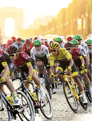  ??  ?? TEAM INEOS PROTECTS WINNER EGAN BERNAL ON THE FINAL STAGE OF THE 2019 TOUR DE FRANCE, IN PARIS.