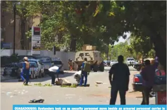  ??  ?? OUAGADOUGO­U: Bystanders look on as security personnel move beside an armored personnel carrier in Ouagadougo­u, as the capital of Burkina Faso came under multiple attacks targeting the French embassy, the French cultural centre and the country’s...