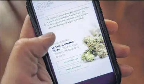 ?? CP PHOTO ?? The Ontario Cannabis Store website is pictured on a mobile phone Ottawa on Thursday.