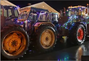  ??  ?? Tractors covered with Christmas lights.