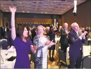  ?? Dan Haar / Hearst Connecticu­t Media ?? Lt. Gov.-elect Susan Bysiewicz, left, reacts to a shout out from Gov.-elect Ned Lamont Monday night at a Democratic Party celebratio­n in Hartford. Others shown are from left Cathy Malloy, Attorney General George Jepsen and Ryan Drajewicz, Lamont’s chief of staff. Many people at the party angled for state jobs.