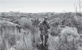  ?? JOHNNY MILANO The New York Times file ?? A member of Arizona Border Recon, a civilian paramilita­ry group, patrols the southern border with Mexico, south of Arivaca, Arizona in April.