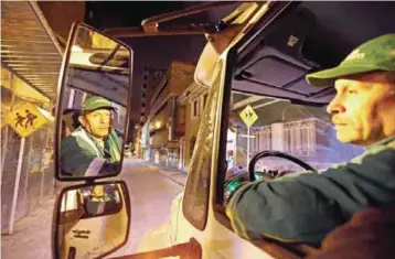  ??  ?? Jose Alberto Gutierrez drives a garbage truck in Bogota, Colombia.