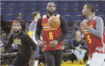  ?? AP PHOTO ?? ALMOST TIME: Kyrie Irving, LeBron James and JR Smith hit the court yesterday in Oakland as they prepare to face the Warriors in Game 1 of the NBA Finals tonight.