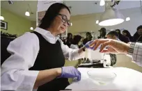  ??  ?? ALAMEDA, California: In this Nov 30, 2016 photo, Lan-Anh Truong performs a manicure at her Leann’s Nails salon. —AP