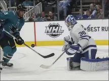  ?? JEFF CHIU — THE ASSOCIATED PRESS ?? Sharks left wing Evander Kane’s shot is defended by Maple Leafs goalie Jack Campbell during the first period Tuesday night. For a report on the game and more on the Sharks, please go to mercurynew­s.com/sports