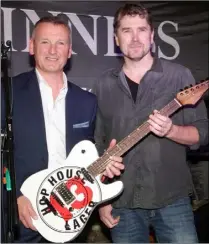  ??  ?? Brian Cantwell (Diageo) with luthier Martin Murphy and the guitar he made as a prize for the best guitarist of the competitio­n.