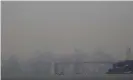  ?? Photograph: Ben Margot/AP ?? Smoke from wildfires obscures a view of the San Francisco skyline and the San Francisco-Oakland Bay Bridge last month as seen from Oakland, California.