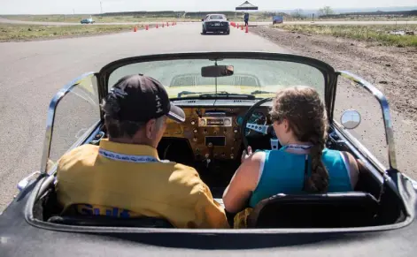  ?? Mike Kvackay, provided by Hagerty ?? William Taylor lets Kimber Burns, a 24-year-old from Castle Rock, drive his 1966 Lotus Elan during a Hagerty Driving Experience in Golden on May 13, 2017. The session was aimed at teaching millennial­s the joy of manual transmissi­on cars.