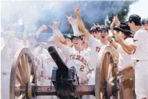  ?? PHOTO CREDIT ?? Texas infielder Kody Clemens (2) and his teammates fire the school cannon after earning a spot in the College World Series Monday. The Longhorns beat Tennessee Tech, 5-2, to advance.