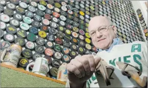  ?? GORD WALDNER/THE Starphoeni­x ?? Bill Seymour shows off his collection in 2007 which includes an ancient pair of hockey blades, up to 2,000 pucks and the Huskies hockey jersey
he wore when he played for the U of S.