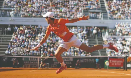  ?? JULIAN FINNEY/GETTY IMAGES ?? Serbia's Novak Djokovic plays a backhand during Sunday's men's singles final against Stefanos Tsitsipas at the Italian Open in Rome. Djokovic was dominant in prevailing 6-0, 7-6 (5), registerin­g his sixth-successive victory over the Greek star.