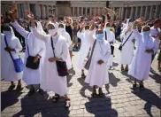  ?? AP- Andrew Medichini ?? Nuns wave to Pope Francis as he recites the Angelus noon prayer from the window of his studio overlookin­g St. Peter’s Square, at the Vatican, on Aug. 16.