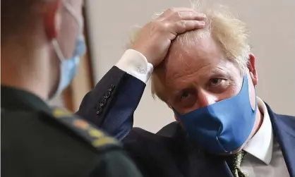  ?? Photograph: Ben Stansall/AP ?? Boris Johnson wears a face mask during a visit to the headquarte­rs of the London ambulance service NHS trust on Monday.