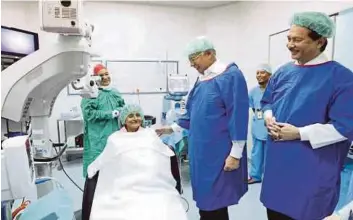  ?? PIC FROM NAJIB’S FACEBOOK ?? Prime Minister Datuk Seri Najib Razak greeting a patient at the MAIWP-Selayang Hospital Cataract Surgery Centre in Kuala Lumpur yesterday. With him is Health director-general Datuk Dr Noor Hisham Abdullah (right).