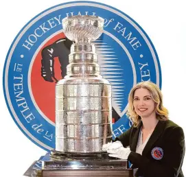  ?? Chris Young/Associated Press ?? Cup Keeper Miragh Bitove is photograph­ed with the Stanley Cup at the Hockey Hall of Fame in Toronto on April 11.