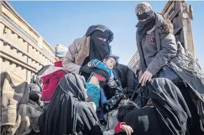  ?? PHOTO: GETTY IMAGES ?? Escaping violence . . . Civilians who have fled fighting in Bagouz wait to board trucks after being screened by members of the Syrian Democratic Forces (SDF) yesterday.