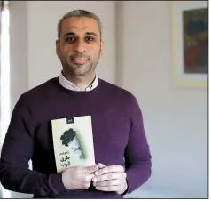  ?? AP/MATT DUNHAM ?? Journalist Shady Lewis Botros poses with a copy of his book, Ways of the Lord, in London. The new Arabic-language novel, the author’s first, explores the lives of Egyptian Christians, dealing with discrimina­tion but also a church aligned with a state seeking to control them.