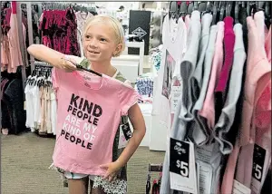  ?? AP/Tyler Morning Telegraph/SARAH A. MILLER ?? Kenadi Wade, 7, shops this week with her grandparen­ts at a J.C. Penney store in Tyler, Texas. Though Penney reported a quarterly loss Friday of $62 million, the department store chain said back-toschool sales were off to a “good start.”