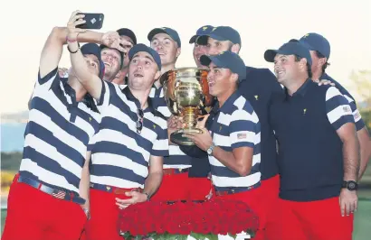  ?? Picture: Getty Images ?? WATCH THE BIRDIE. Justin Thomas takes a picture with his team-mates as the Americans celebrate their resounding Presidents Cup triumph at Liberty National Golf Club on Sunday.